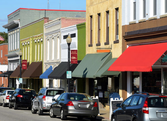 Cars parked on the street with businesses with Small Business Insurance in Oneonta, NY 