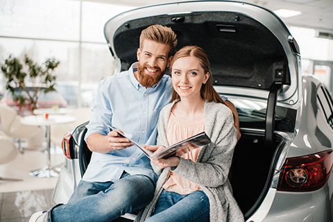 Couple sitting in the back of a vehicle with Car Insurance in Walton, Hobart, Oneonta, Margaretville, NY, Andes, NY, Delhi, NY