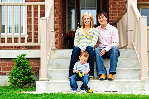 Family Sitting on Front Porch Steps with Oeonta, NY 